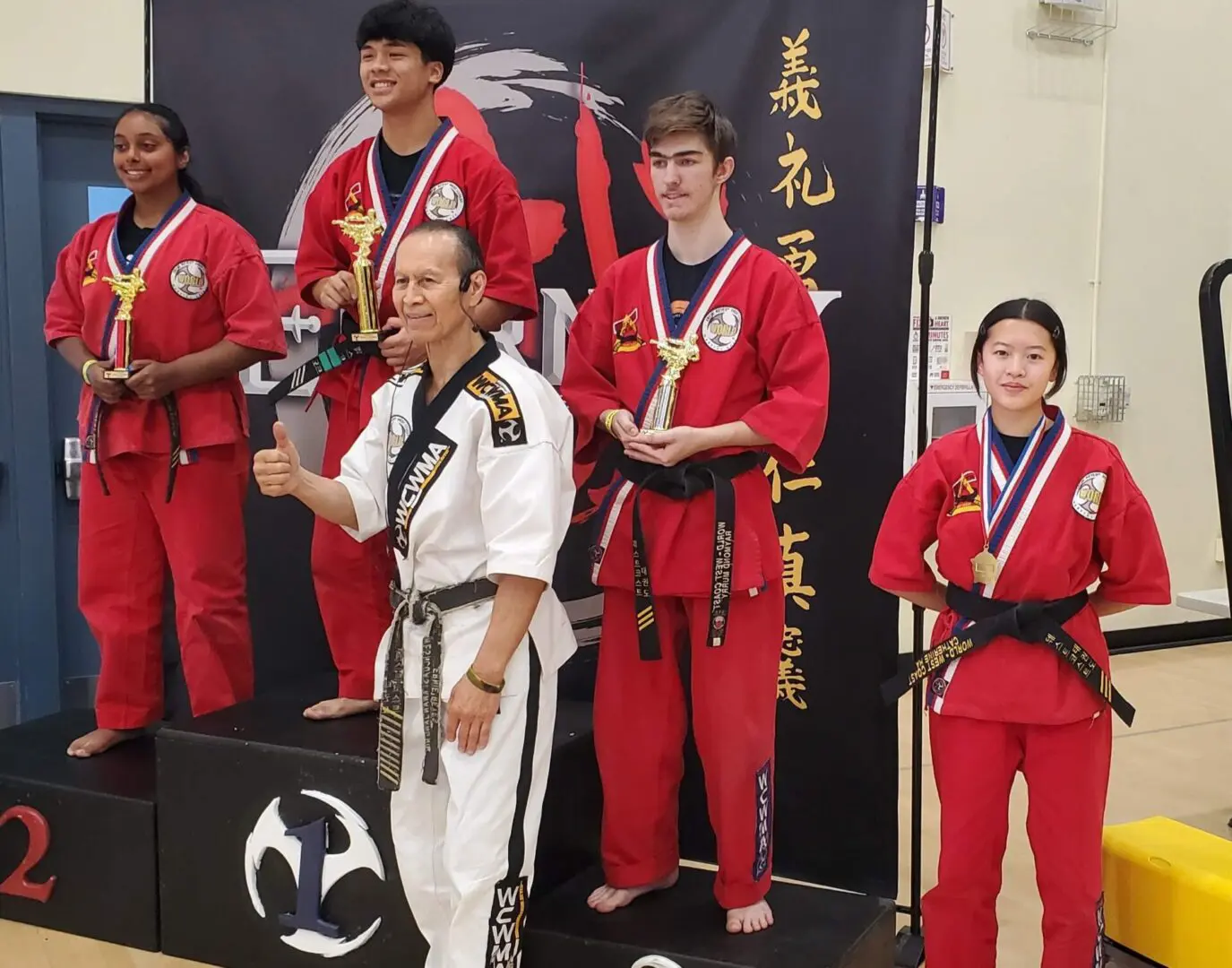 A group of people in red and black uniforms standing on top of a stage.