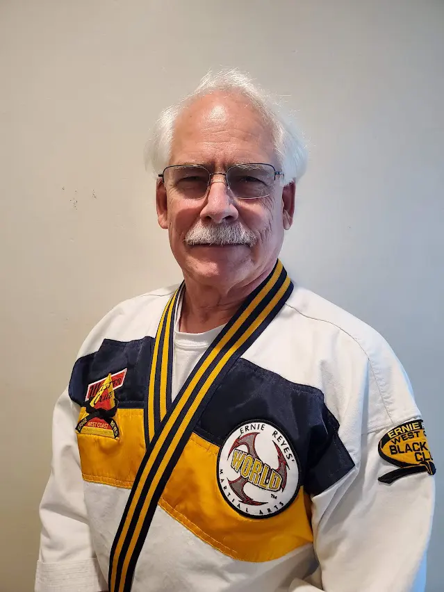 A man in a white and yellow uniform standing up.