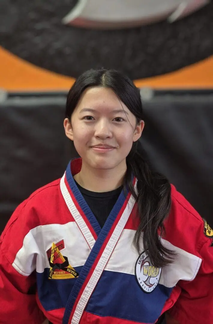 A young girl in a red and white uniform.